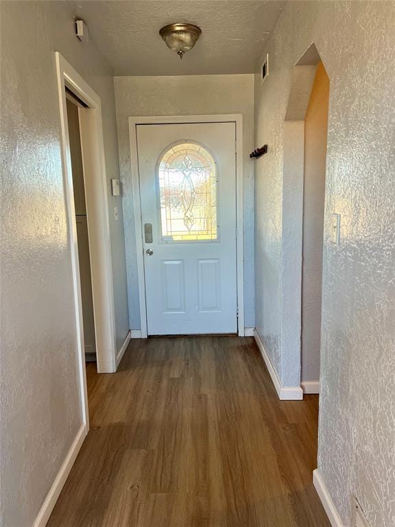 entryway with dark wood-type flooring