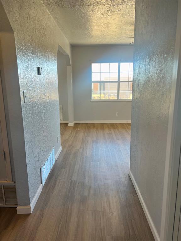 interior space featuring hardwood / wood-style floors and a textured ceiling