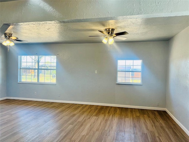 unfurnished room with ceiling fan, hardwood / wood-style floors, and a textured ceiling