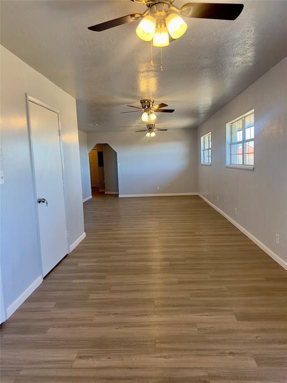 unfurnished room featuring hardwood / wood-style floors, a textured ceiling, and ceiling fan