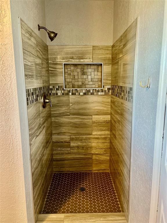 bathroom with a tile shower