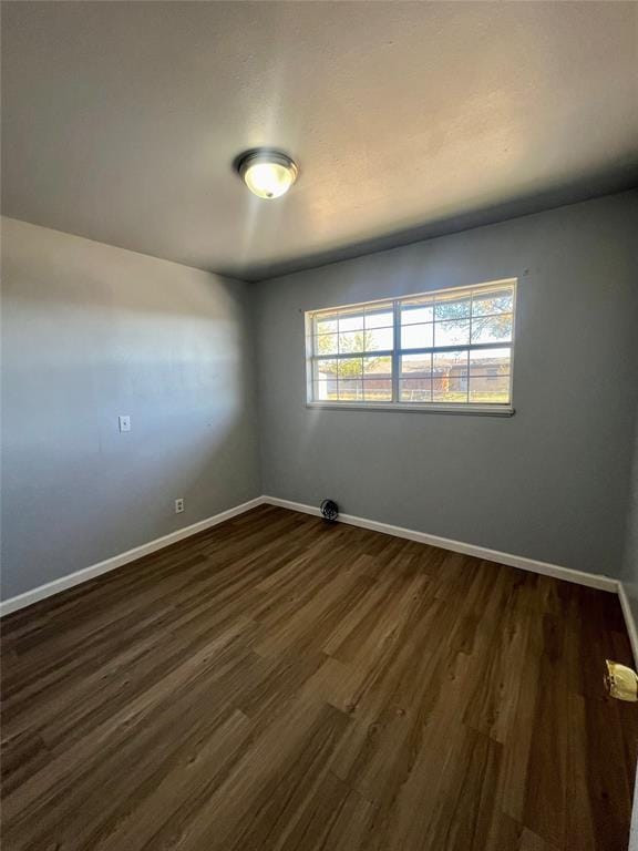 spare room featuring dark hardwood / wood-style floors