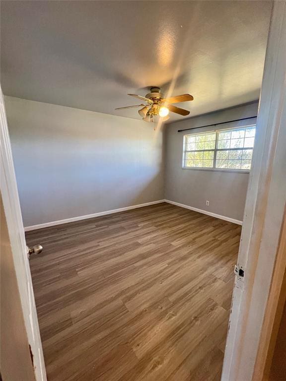 unfurnished room featuring ceiling fan and hardwood / wood-style floors