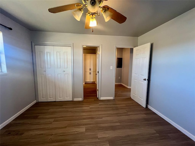 unfurnished bedroom featuring ceiling fan, dark wood-type flooring, and a closet