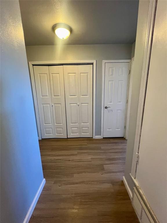 corridor featuring dark hardwood / wood-style flooring