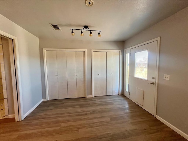 entryway with hardwood / wood-style floors