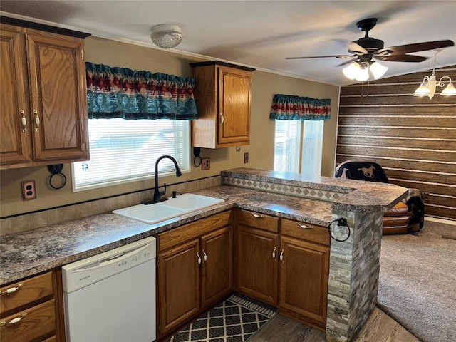 kitchen with kitchen peninsula, dishwasher, plenty of natural light, and sink