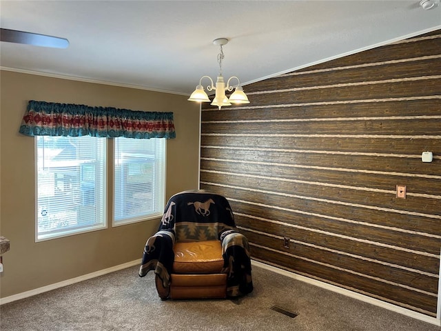 living area featuring carpet, vaulted ceiling, crown molding, and a chandelier