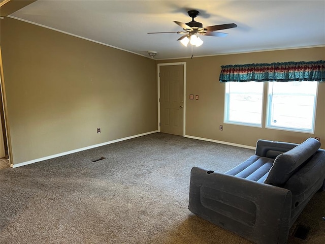 living room featuring carpet, ceiling fan, and crown molding