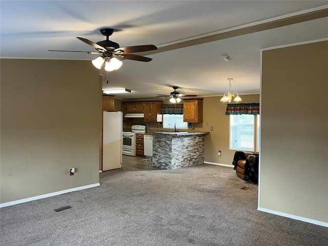 unfurnished living room featuring dark colored carpet, ceiling fan with notable chandelier, and ornamental molding