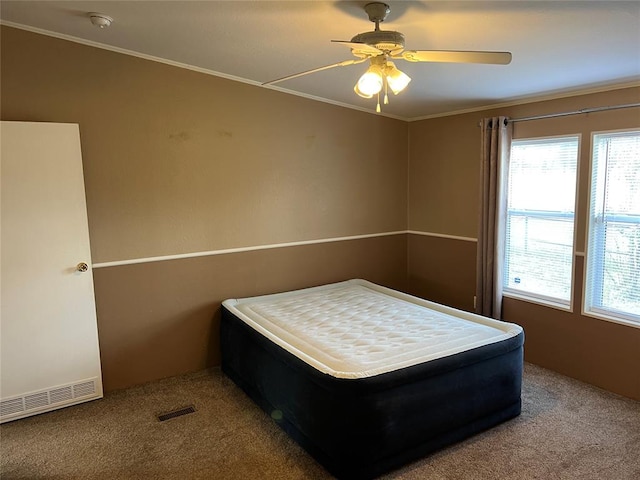 bedroom featuring carpet flooring, ceiling fan, and crown molding