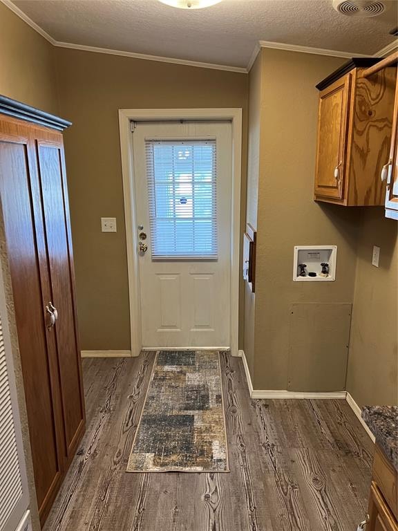 doorway featuring a textured ceiling, dark hardwood / wood-style flooring, lofted ceiling, and ornamental molding