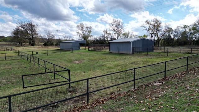 view of yard featuring a rural view and an outdoor structure