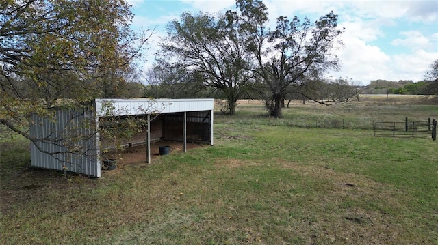 view of yard with a rural view and an outdoor structure