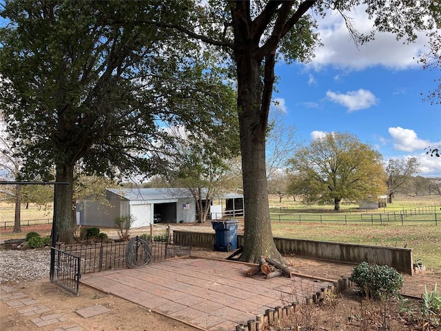 view of yard featuring an outbuilding and a rural view