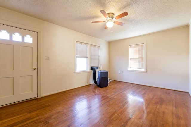 entryway with a textured ceiling, hardwood / wood-style flooring, and ceiling fan