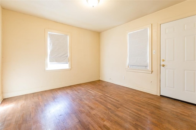 empty room with hardwood / wood-style flooring