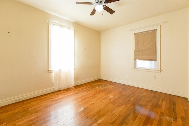 empty room featuring hardwood / wood-style flooring, plenty of natural light, and ceiling fan