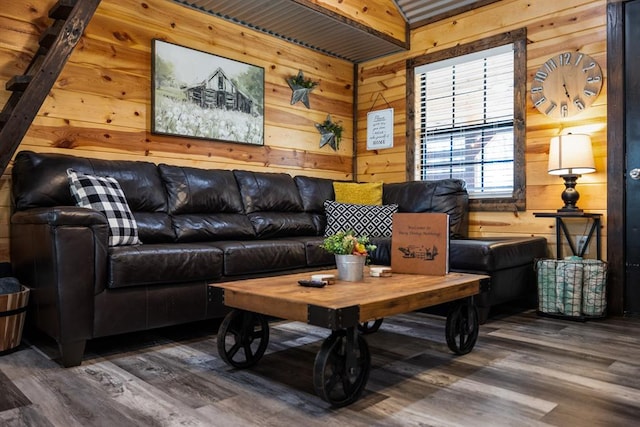 living room with beamed ceiling, dark wood-type flooring, and wood walls