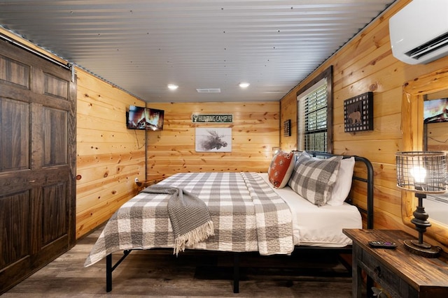 bedroom with a wall mounted air conditioner and wood walls