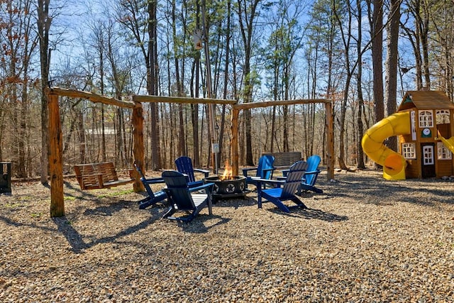 view of jungle gym with a fire pit