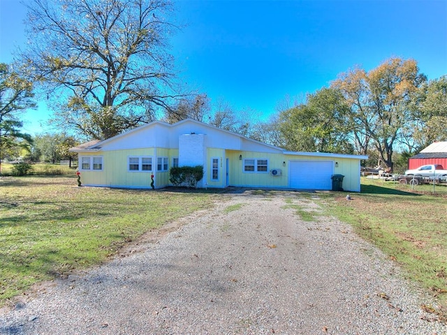 single story home with a garage and a front yard