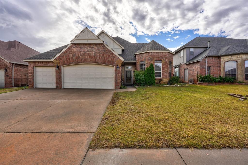 view of front of home with a garage and a front lawn