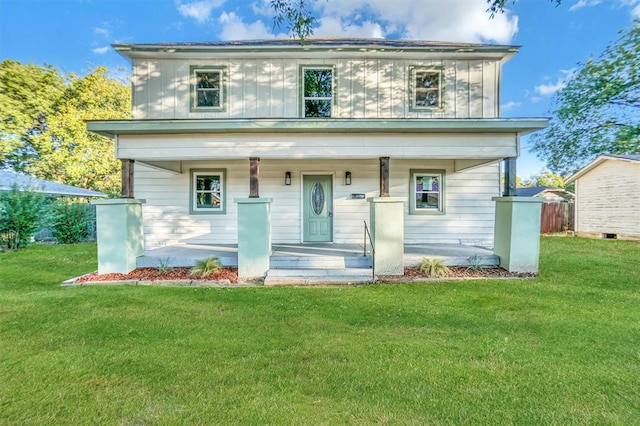 view of front facade with covered porch and a front yard