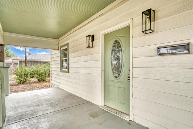 view of exterior entry with covered porch