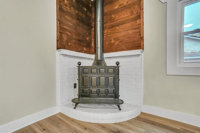 details with hardwood / wood-style floors and a wood stove