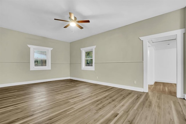 empty room featuring ceiling fan and light wood-type flooring