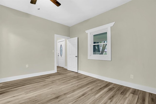 spare room with light wood-type flooring and ceiling fan