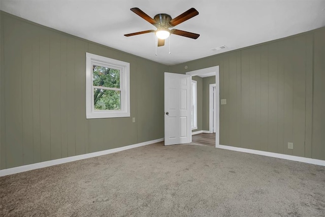 spare room with carpet flooring and ceiling fan