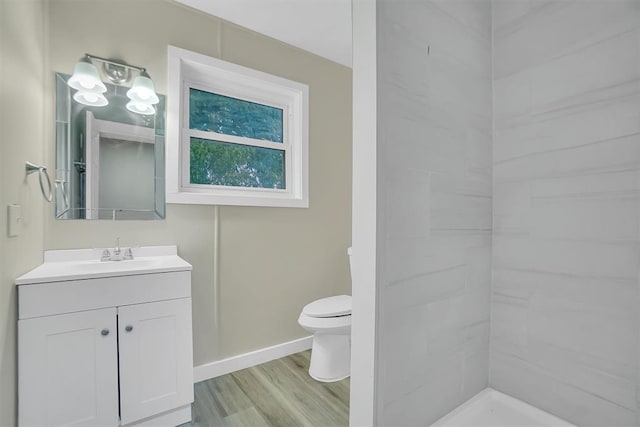 bathroom featuring toilet, vanity, and hardwood / wood-style flooring