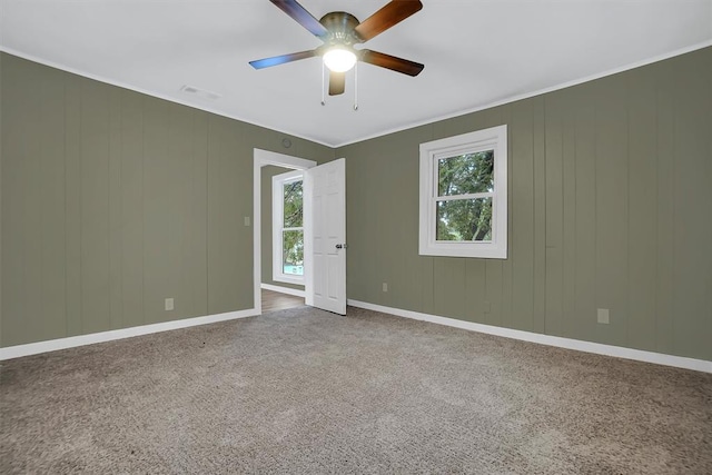 carpeted spare room featuring ceiling fan