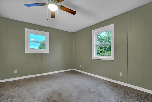 carpeted empty room featuring ceiling fan