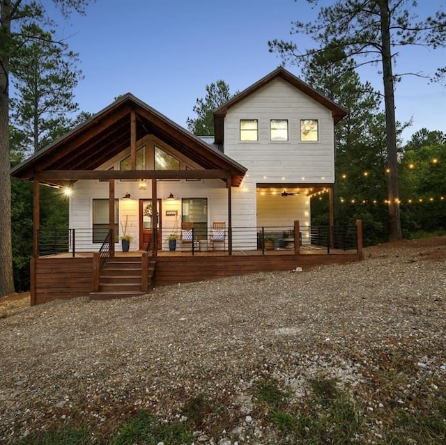 back house at dusk with a porch