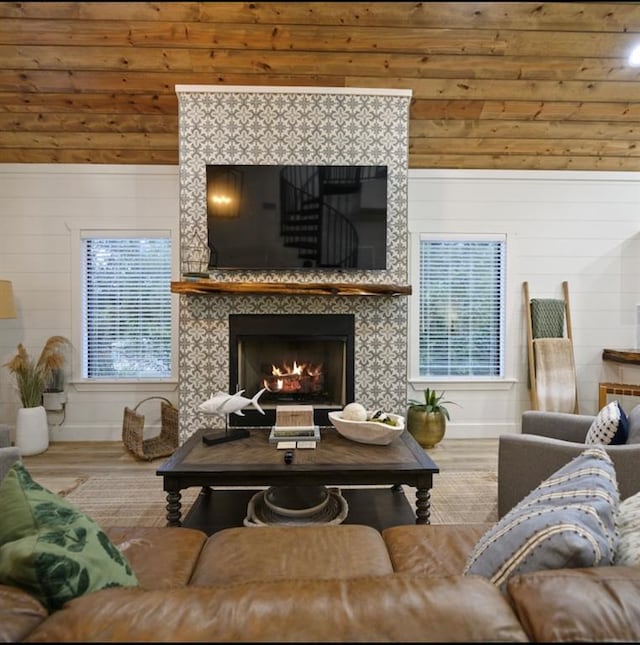 living room with hardwood / wood-style floors, plenty of natural light, and wooden walls