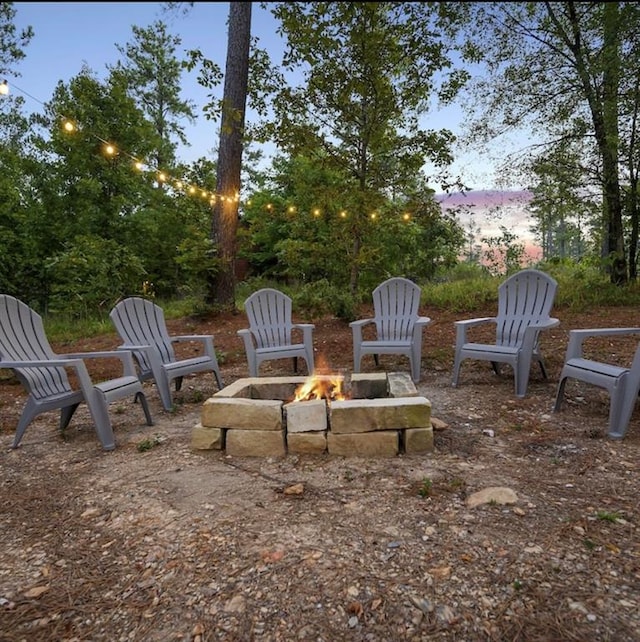 patio terrace at dusk featuring an outdoor fire pit