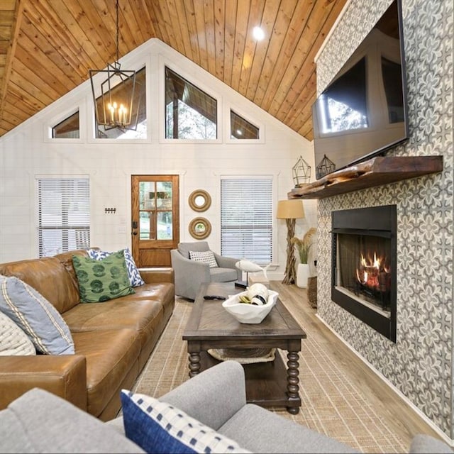 living room with a chandelier, light hardwood / wood-style flooring, high vaulted ceiling, and wood ceiling