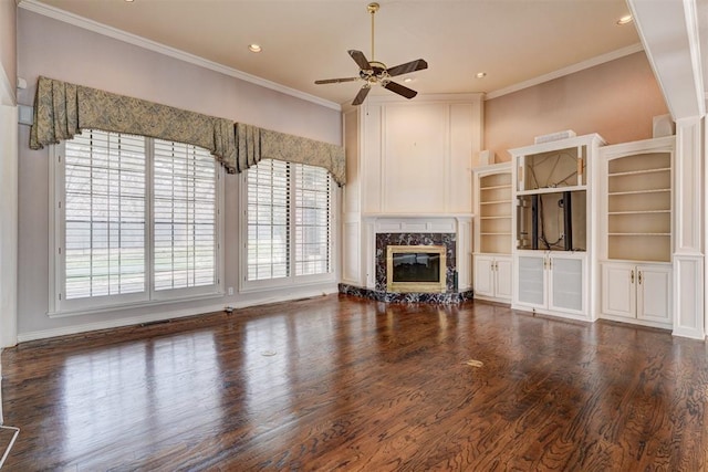 unfurnished living room with wood finished floors, a premium fireplace, recessed lighting, ceiling fan, and crown molding