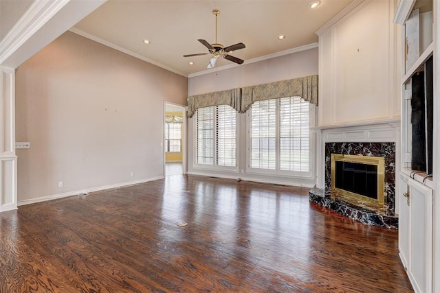 unfurnished living room with plenty of natural light, wood finished floors, and a premium fireplace