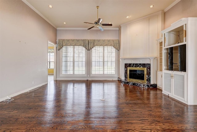 unfurnished living room with dark wood-style floors, plenty of natural light, a fireplace, and ornamental molding