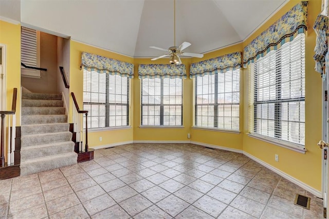 interior space with visible vents, ceiling fan, and vaulted ceiling