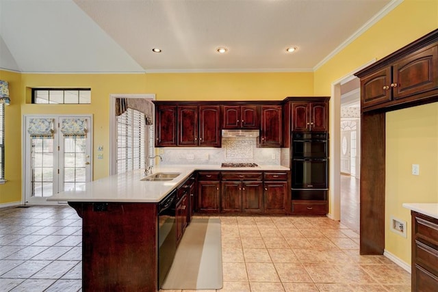 kitchen featuring black appliances, a sink, under cabinet range hood, light countertops, and dark brown cabinets