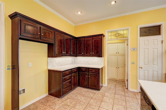 kitchen featuring decorative backsplash, light countertops, baseboards, and ornamental molding