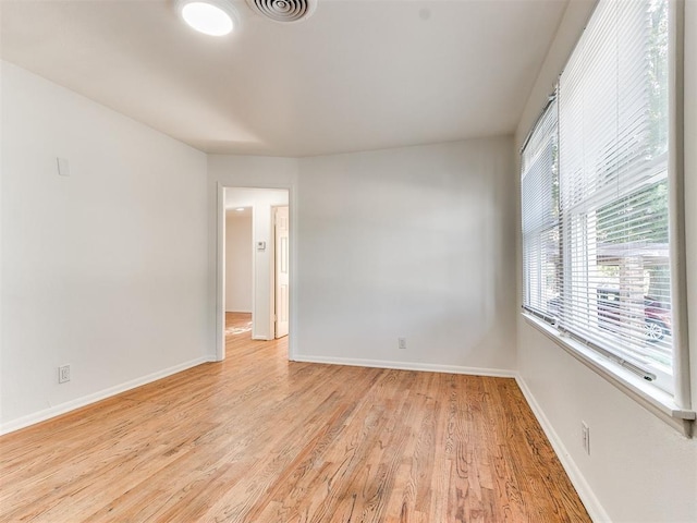 spare room with light hardwood / wood-style flooring