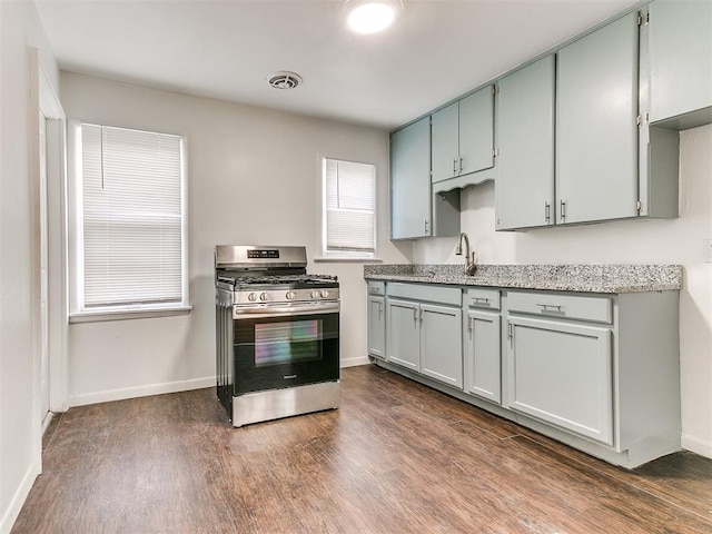 kitchen with sink, dark hardwood / wood-style floors, and stainless steel range with gas stovetop