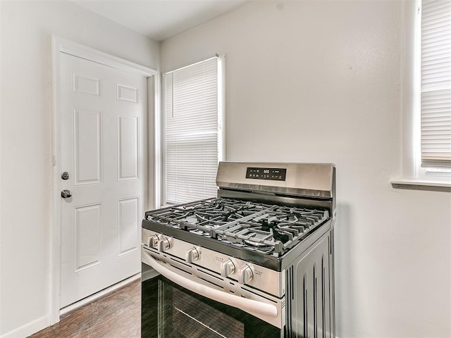 kitchen featuring dark hardwood / wood-style floors and stainless steel range with gas cooktop