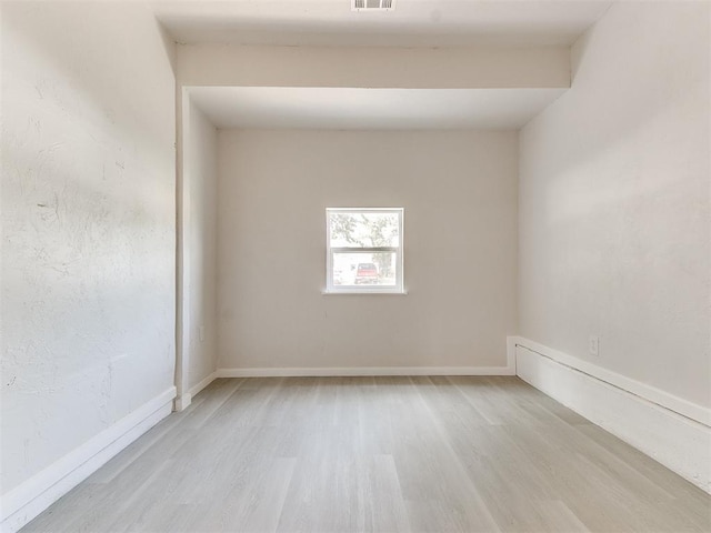 unfurnished room with light hardwood / wood-style flooring